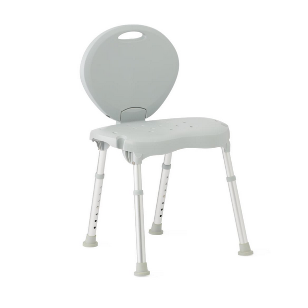 The Medline Folding Portable Shower Chair in light gray features a rounded backrest, contoured seat, adjustable height, and slip-resistant aluminum legs with rubber feet. It has a handle cutout on the backrest for easy carrying.